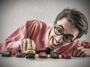 photodune-9301307-businessman-playing-with-little-cars-m